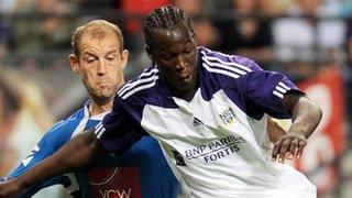 TNS defender Steve Evans tussles for the ball with Romelu Lukaku against Anderlecht, August 2010