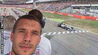 Lukas Podolski enjoys the German Grand Prix