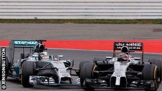 Jenson Button and Lewis Hamilton collide in the German Grand prix.