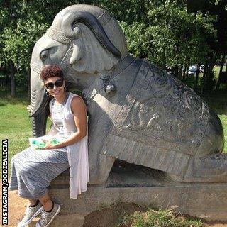 Jodie Williams sits next to an elephant statue