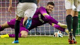 Fraser Forster saves a penalty for Celtic against Legia Warsaw