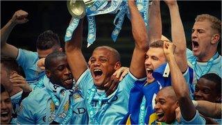 Manchester City players celebrate winning the Premier League title