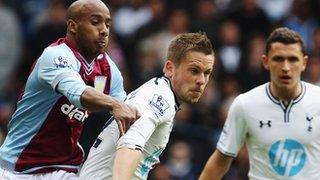 Gylfi Sigurdsson battles for the ball with Fabian Delph