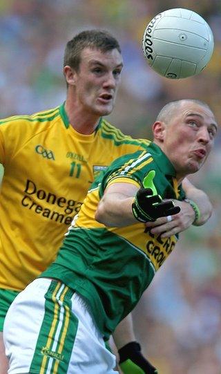 Donegal's Leo McLoone takes a firm grip on Kieran Donaghy as the pair battle for possession