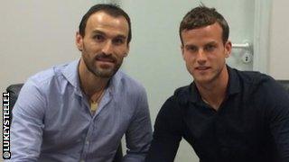 Luke Steele (right) with Panathinaikos technical director Nikos Dabizas