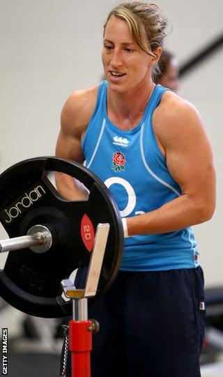 Kat Merchant lifts weights in a gym