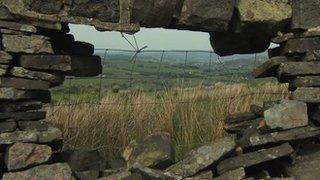 view of the Pennine Way through stone wall along trail