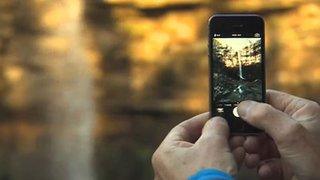 a picture of a waterfall being taken with a mobile phone