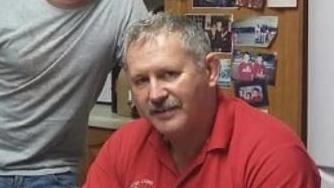 Mike O'Leary - A man in a red polo shirt with grey hair and a grey moustache