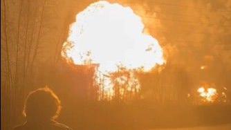 A drone strike at the Ryazan oil refinery near Moscow in January caused a massive blast, forcing it to temporarily suspend operations. In the image a man stands watching a fireball erupt from the refinery in the near distance. 
