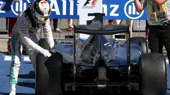 Lewis Hamilton checks his Mercedes tyre after the Italian Grand Prix