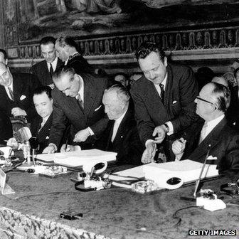 Former West German Chancellor Konrad Adenauer (centre) signs The Treaty of Rome in 1957