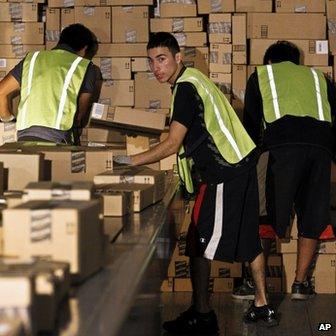 Workers pack a lorry at the Amazon.com plant in Phoenix, Arizona, on 26 November 2012