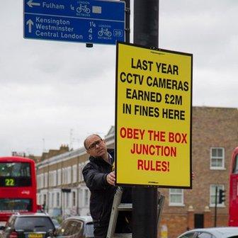 Adam Shaw with road sign