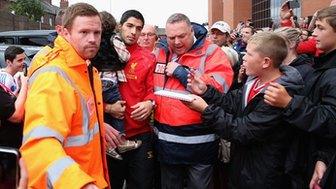 Liverpool striker Luis Suarez is mobbed by the club's fans at Anfield