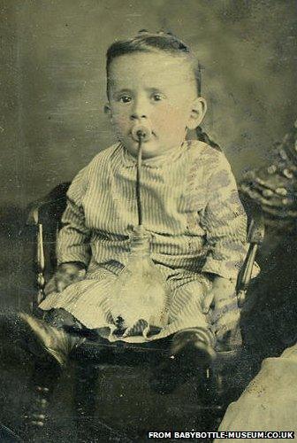 Child drinks from antique bottle