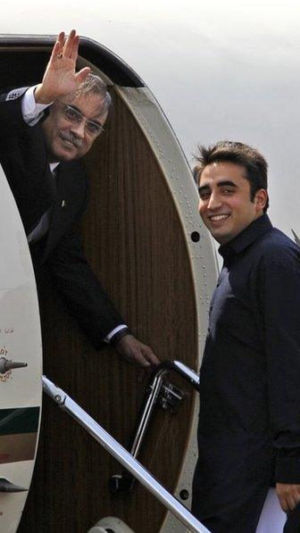 The Pakistani President Asif Ali Zardari, left, waves as his son Bilawal Bhutto Zardari looks on, at an airfield in New Delhi, India, in April 2012