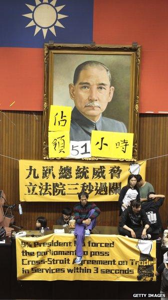 Students sit in from of Sun Yat Sen portrait in Taiwanese parliament