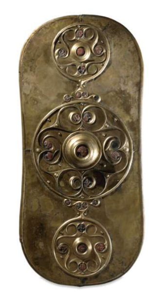 A bronze-coloured shield facing with engraved decorations