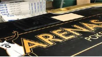 A photo of a poker table bearing Mr Arena's name and image was listed as evidence by prosecutors. IN the photo you can see the words "Arenas Poker Club" on a gambling table