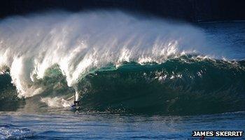 Surfer riding big wave Mullaghmore