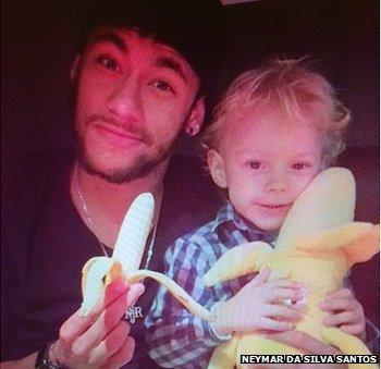 Neymar, side by side with his son, holding a banana