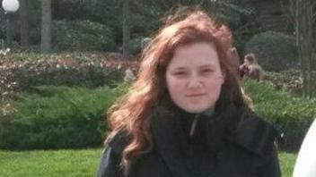 A picture of Leah Croucher, a teenage girl with long brown hair, standing in a park