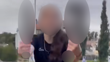 A picture of a teenager holding items that have been blurred for legal reasons. The teenager's identity has also been hidden