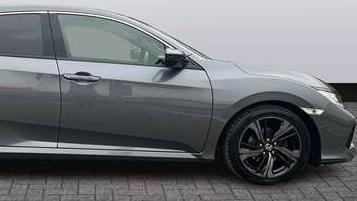 A side view of a grey Honda Civic. 