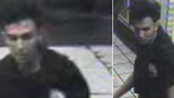 A blurred CCTV image of a young man in a London underground station. He has dark hair and is wearing a black polo shirt.