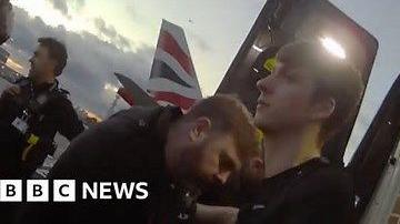 Thomas Dures being arrested with plane behind him