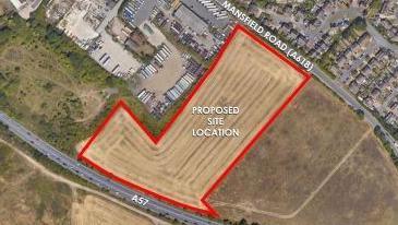 An aerial shot of fields, streets and houses between Mansfield Road and the A57. One field is outlined in red and labelled "proposed site location" in white letters.