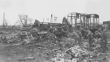 A group of people clearing debris following an ammunitions explosion at Catterick, North Yorkshire, in 1944. 