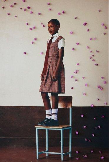 Girl in Kenya standing on a chair