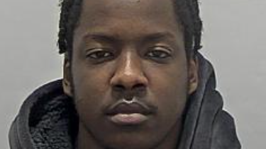 A custody photo shows a young man wearing a dark hoodie