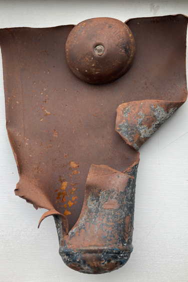 A ripped open canister that previously contained nitrous oxide, which has exploded after being heated at high temperature, or compressed, in a waste facility.