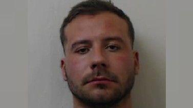 Police mugshot of Ewan Methven who has short brown hair and a beard