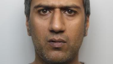 Police custody photo of Janaed Akhtar who has grey stubble and short grey hair