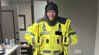 Gang member Mark Kirkwood poses for a photo in his fake police officer uniform