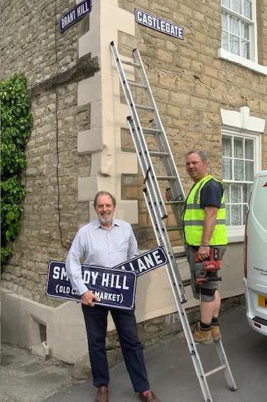 Andrew Gadsby with the new signs as they are being installed in Pickering