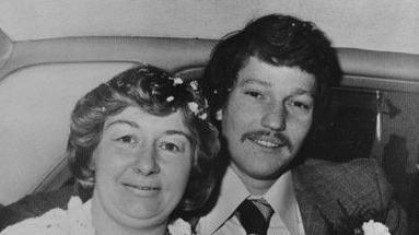 An old photo in black and white of Carol and Allen Morgan on their wedding day