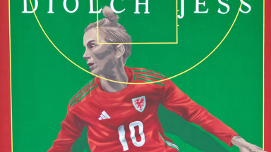 A mural of Jess Fishlock, wearing the Wales number 10 shirt, against a green backdrop