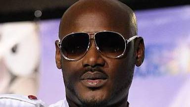 A close-up picture of Tuface. He has a shaved head and is wearing dark glasses