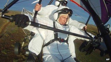 Russian President Vladimir Putin flies in a motorized hang glider alongside a Siberian white crane (image from 5 Sept)