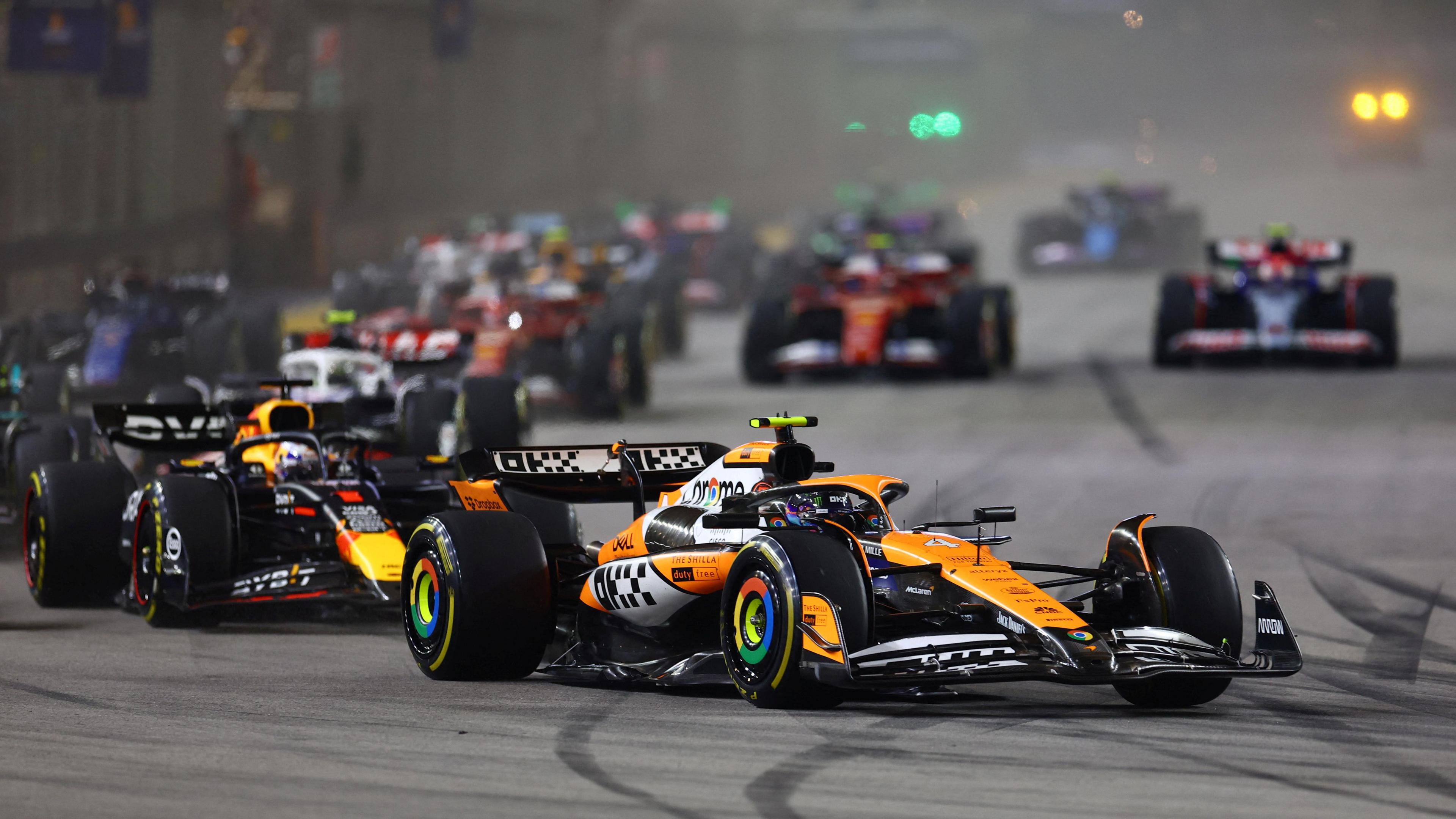 McLaren's Lando Norris leads Red Bull's Max Verstappen and the rest of the field at the start of the 2024 Singapore Grand Prix