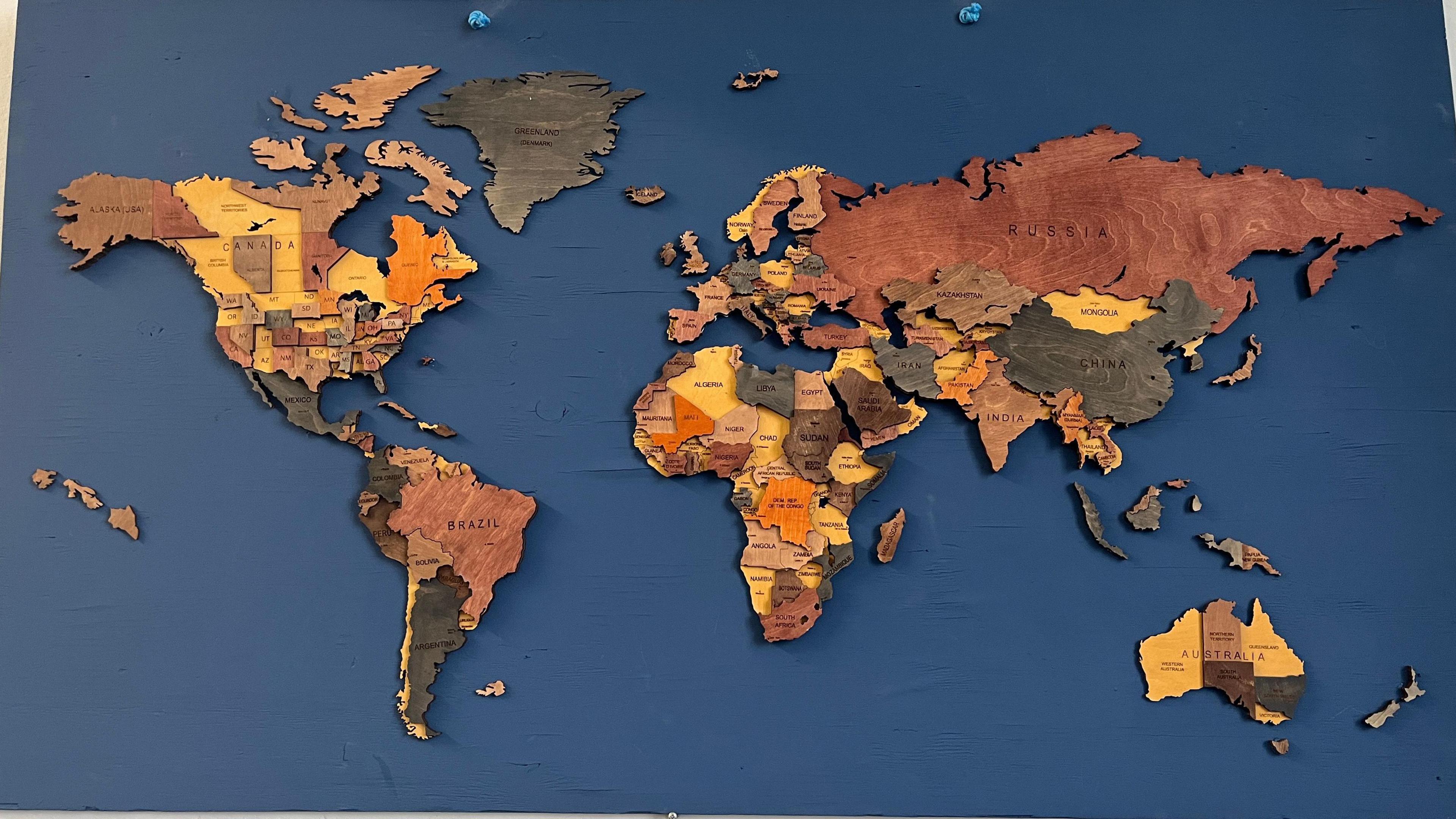 A map of the world made from wood.