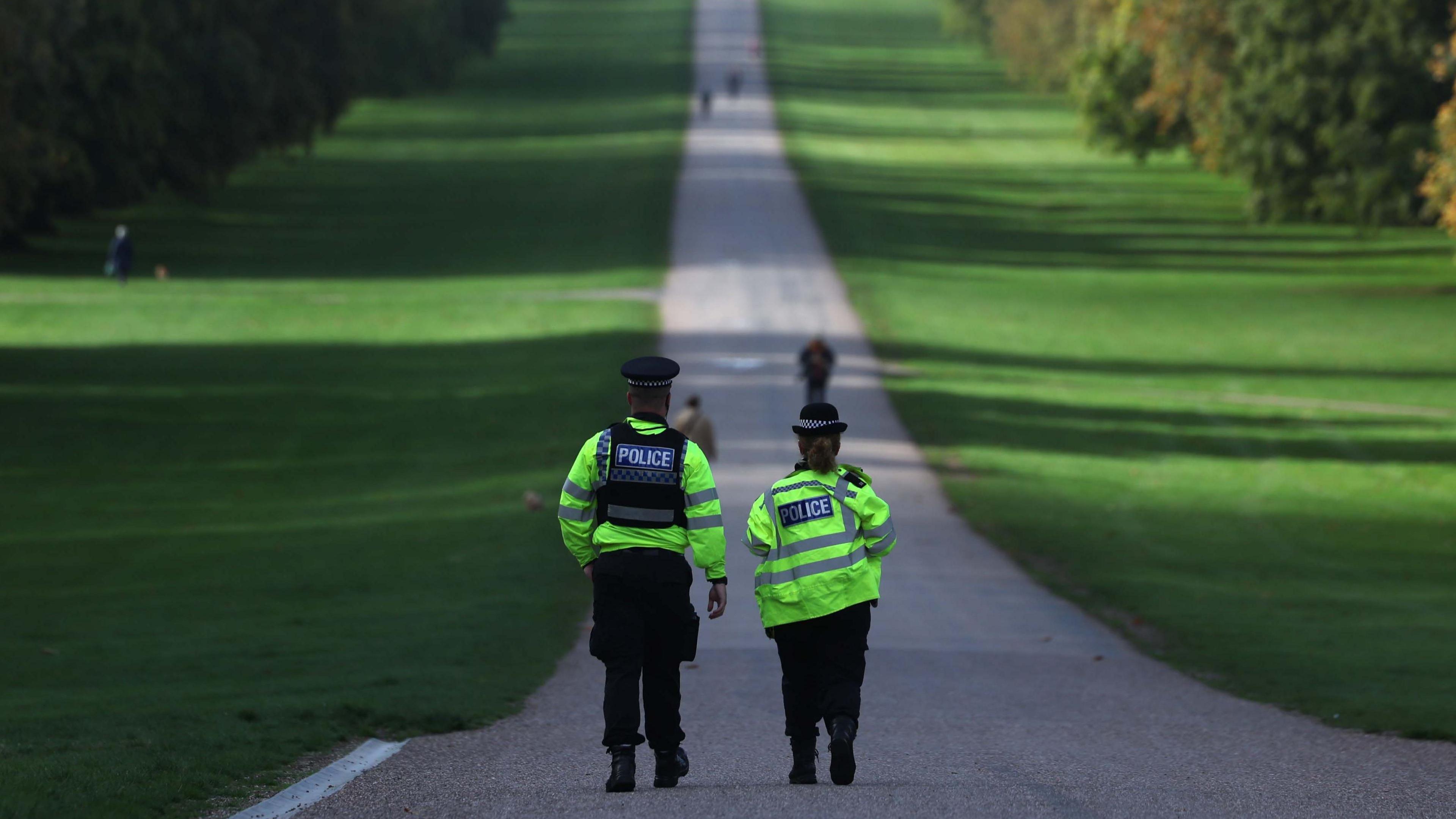 Two police officers walking along the Great Walk near Windsor Castle