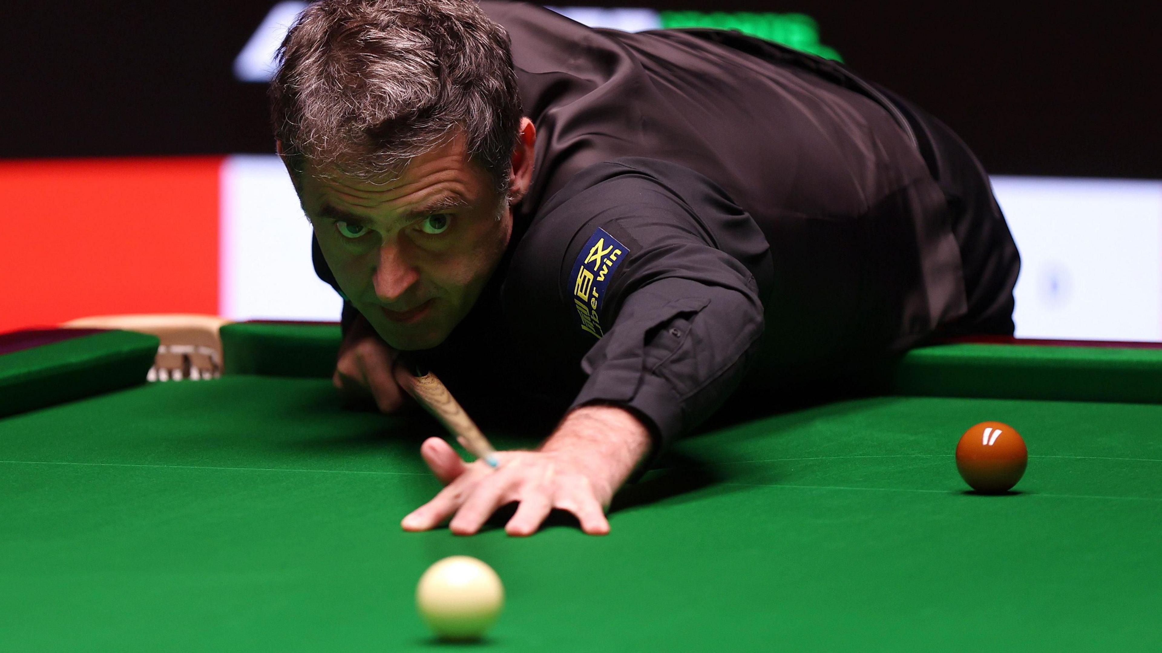 Ronnie O'Sullivan plays a shot