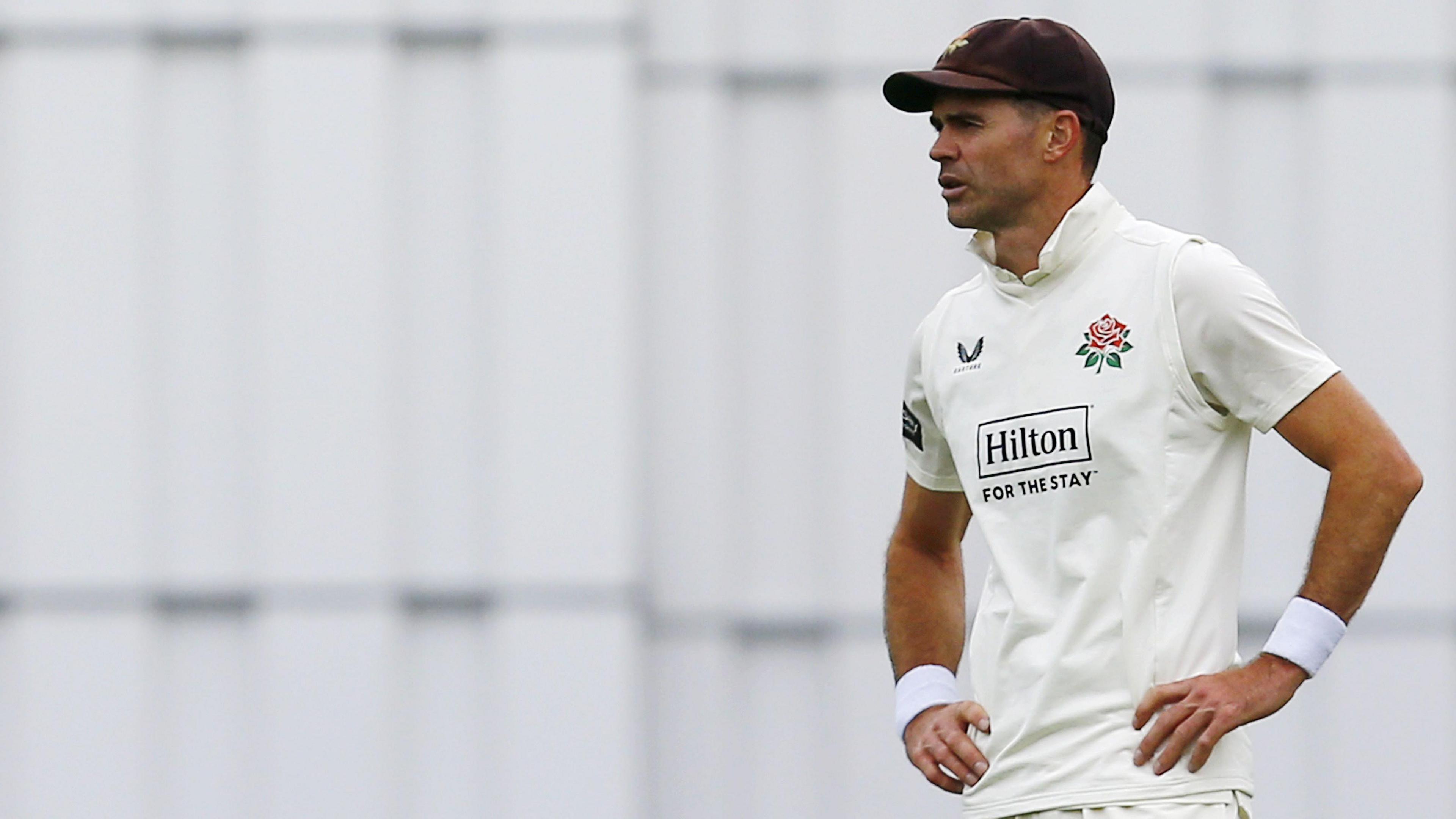 James Anderson stands with his hands on his hips