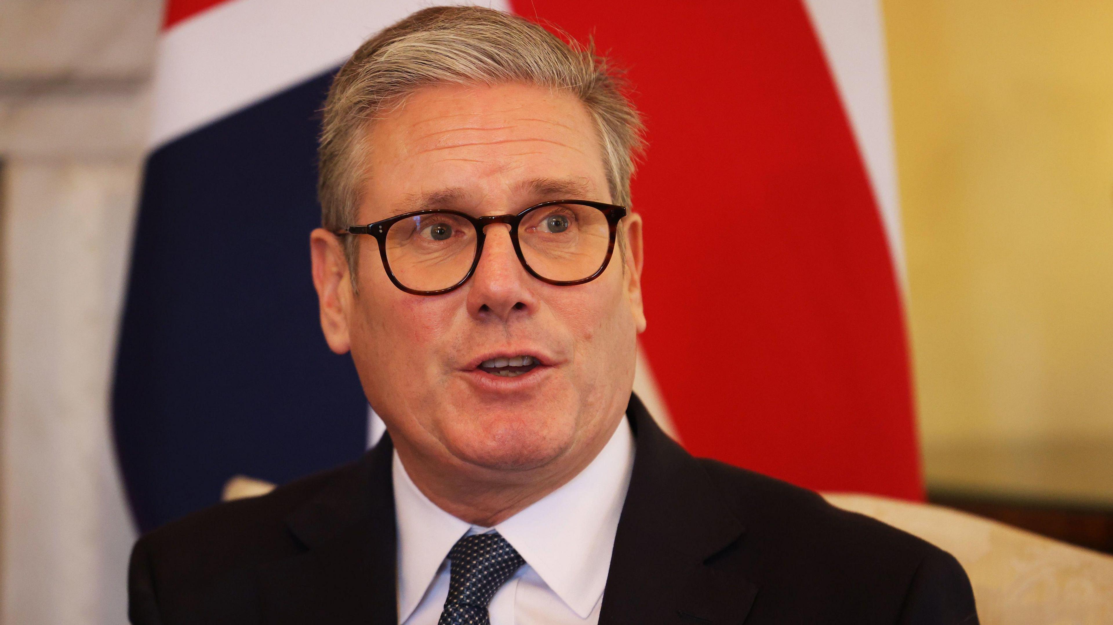 Prime Minister Sir Keir Starmer speaks in front of a Union Flag during a meeting on Ukraine's security with the Nato Secretary General 